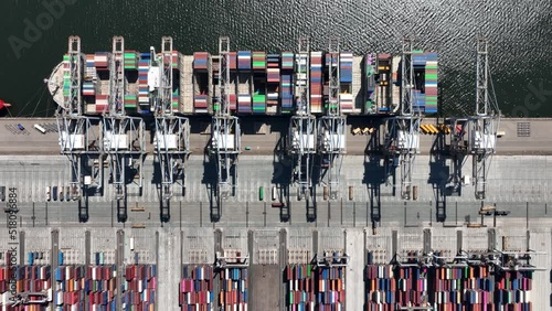 Container shipping terminal in the port harbour. import export and loading and unloading of merchandise of a large bulk vessel and cranes. Holland, The Netherlands