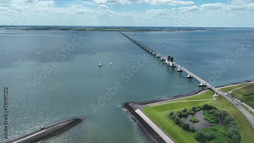 Zeelandbridge infinity bridge in the distance aerial drone view. part of Delta works. Dutch infrastructure holland Zeeland. Transporation delivery logisitics road. Overhead view. Holland. photo