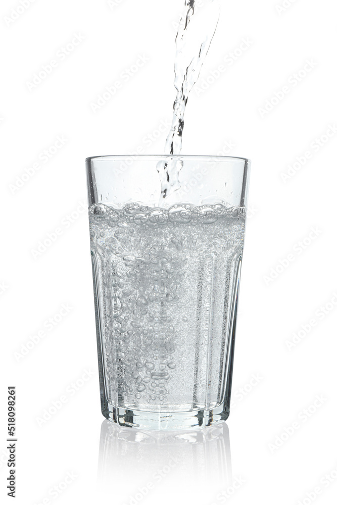 Pouring soda water into glass on white background Pouring soda water into glass on white background