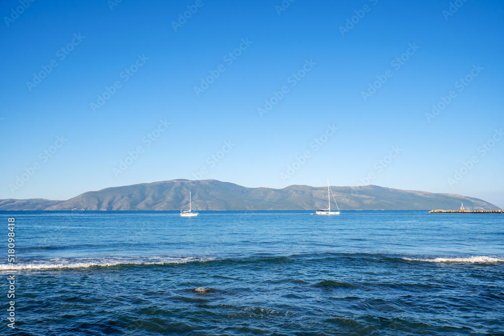 Wooden vessel on the shore of Vlora port. Stunning spring seascape of Adriatic sea. Nice morning scene of Albania, Euroepe. Traveling concept background. Wooden vessel on the shore of Vlora port. Stunning spring seascape of Adriatic sea. Nice morning scene of Albania, Euroepe. Traveling concept background.
