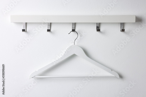 Obraz na plátně Rack with empty clothes hanger on white wall