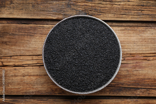Bowl of black sesame on wooden table, top view