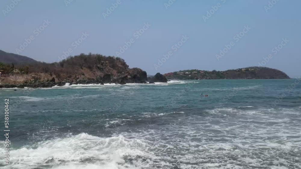 Drone flying over the Ixtapa beach located in the state of Guerrero, Mexico during a sunny day. Drone flying over the Ixtapa beach located in the state of Guerrero, Mexico during a sunny day.