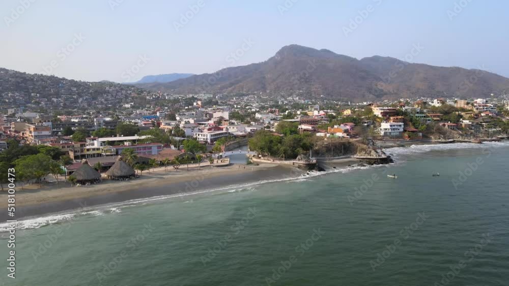 Drone flying over a long distance of Ixtapa beach located in the state of Guerrero, Mexico during a sunny day. Drone flying over a long distance of Ixtapa beach located in the state of Guerrero, Mexico during a sunny day.