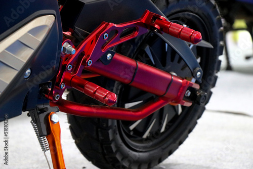 Sport electric motorcycle or side view of new red electric motorbike with stand on