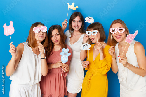 A group of friends, have funny moments, celebrated gender reveals envent, isolated blue background.