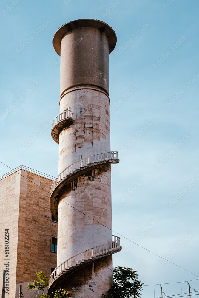View up to the majestic Italian Water tower with stairs around it and with clear blue sky in background