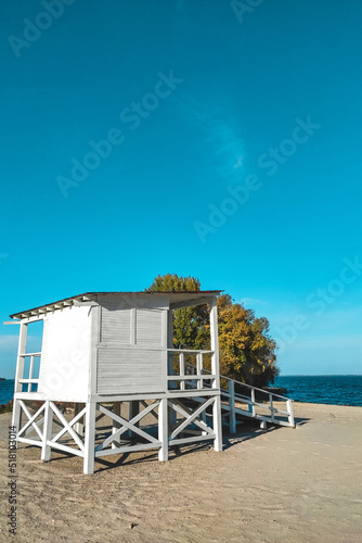 White wooden house for lifeguards on the water at the beach. © ir1ska
