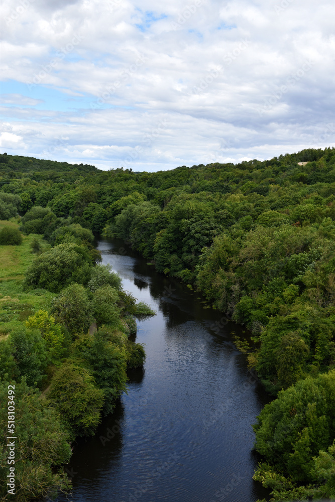 Birds Eye View Over Blue River In Green Forest Woodland