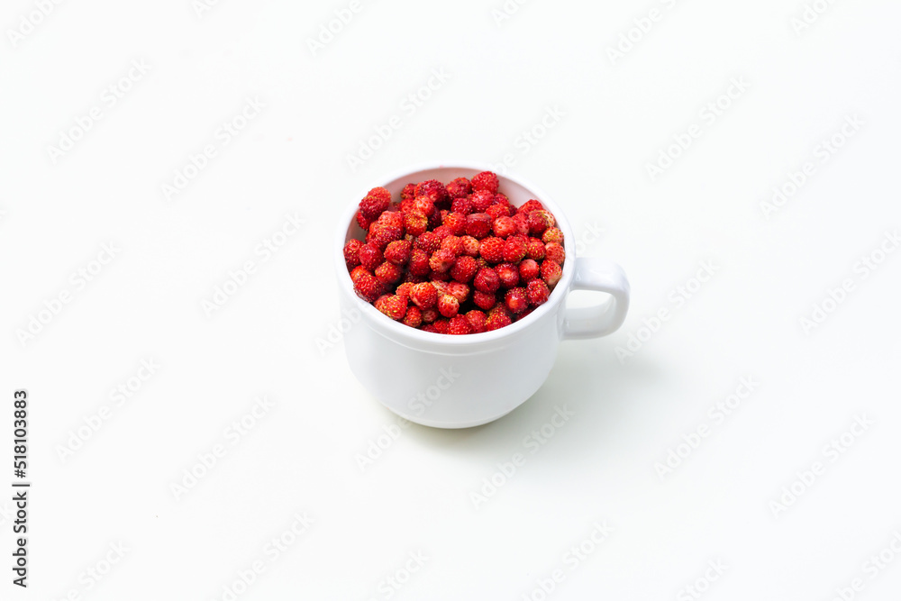 wild strawberries in a white glass on a white background minimalism wild strawberries in a white glass on a white background minimalism