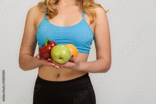 Cropped photo of fit healthy sporty woman having fruits and vegetables for breakfast