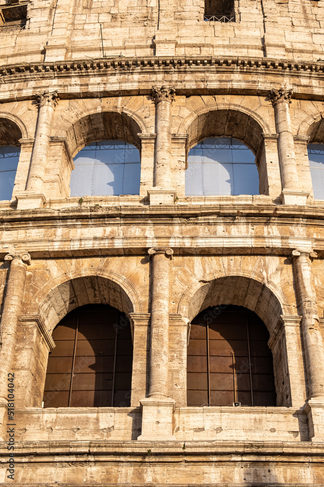 Close - up view of arched windows of fabulous Colosseum in Rome in sunny summer day.