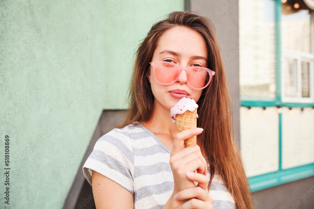Laughing teenage girl eating ice cream cones on city street - Young female enjoying icecream outside - Summer lifestyle concept Laughing teenage girl eating ice cream cones on city street - Young female enjoying icecream outside - Summer lifestyle concept