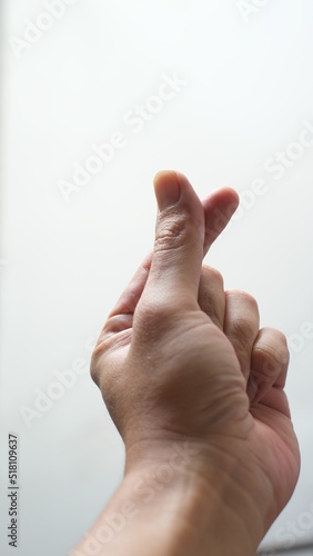 man's fingers creating sign