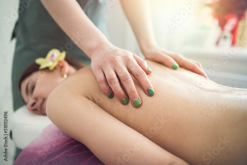 Pretty slim woman receiving a health massage treatment in a spa center