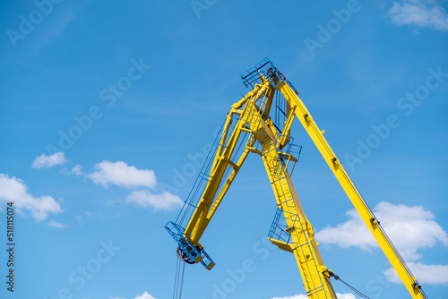 Yellow crane against blue sky