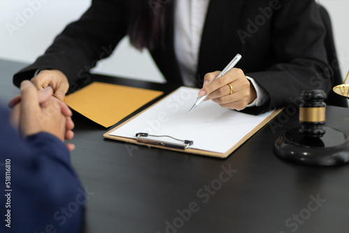 Fototapeta Naklejka Na Ścianę i Meble -  Businessman and lawyers discussing contract papers on wooden desk in office. Law, legal services, advice, Justice concept.