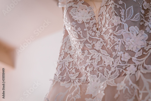 White wedding dress hanging close up shot