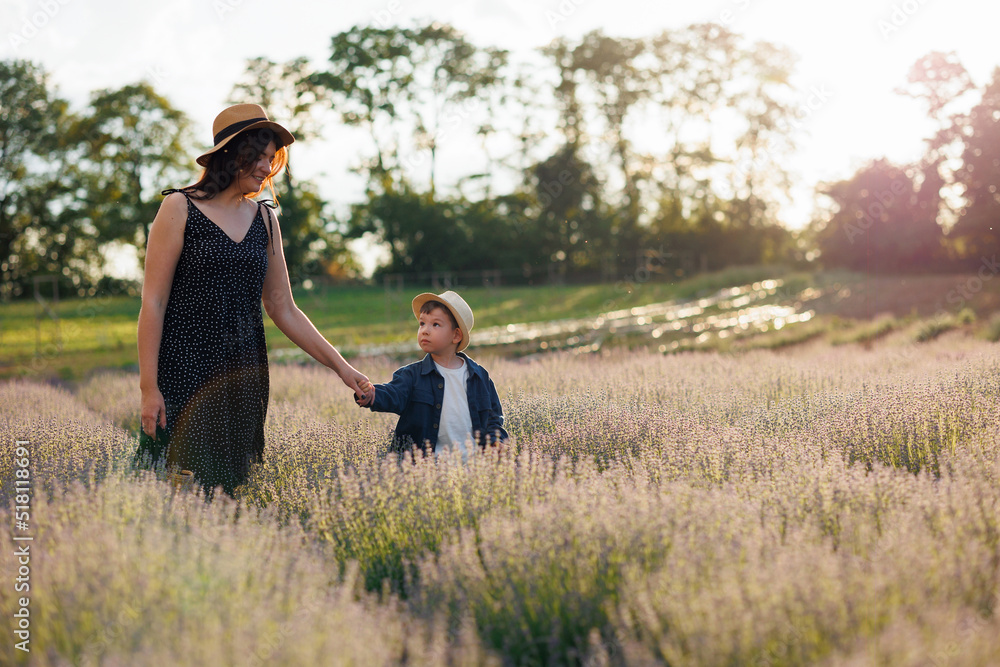 Happy mother and little son spend time together in lavender field Happy mother and little son spend time together in lavender field
