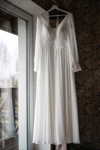 White wedding dress hanging front shot