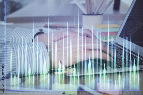 Multi exposure of stock market graph with man working on laptop on background. Concept of financial analysis. © peshkova
