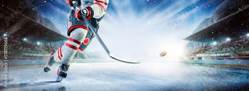 Photography Close up of ice hockey stick on ice rink in position to hit hockey puck
