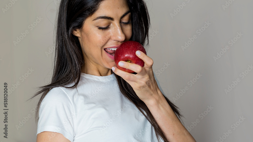 Beautiful Young Woman Eating Red Apple. Healthy Eating and Dental Care Concept Beautiful Young Woman Eating Red Apple. Healthy Eating and Dental Care Concept