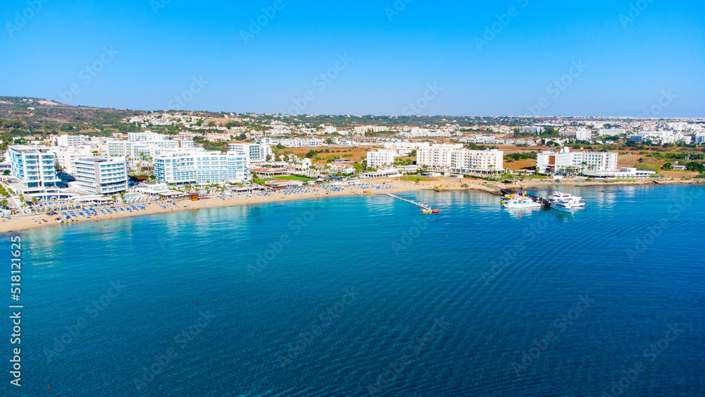 Aerial bird's eye view of Vathia Gonia beach, Ayia Napa, Famagusta, Cyprus. Landmark tourist attraction rocky bay with golden sand, sunbeds, sea restaurants in Agia Napa on summer holidays from above