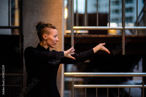 Asian woman trains tai chi in the city, chinese martial arts, healthy lifestyle concept.