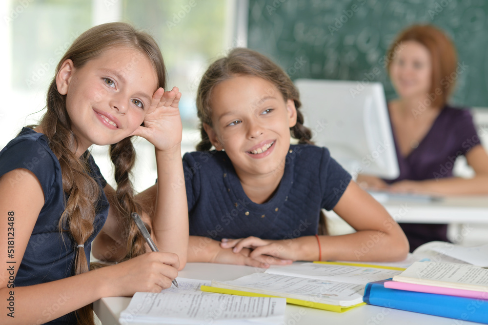 Beautiful girls studying at the desk in class room Beautiful girls studying at the desk in class room