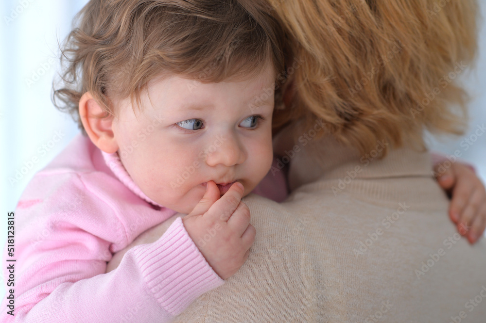 Llittle daughter resting on her mother's shoulder Llittle daughter resting on her mother's shoulder