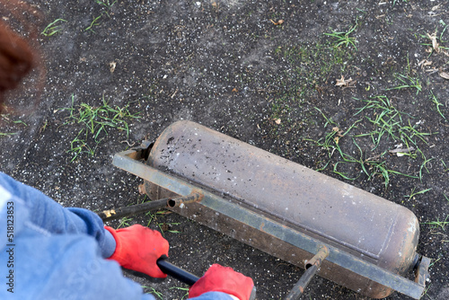Fotografie Person flattening the soil in the traditional way