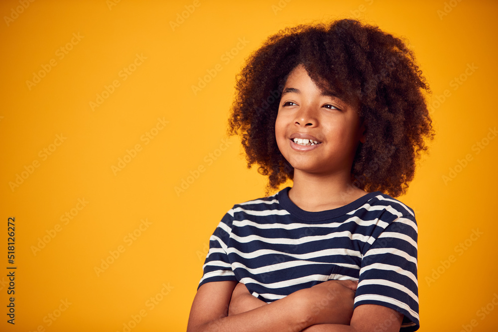 Studio Portrait Of Smiling Young Boy Shot Against Yellow Background Studio Portrait Of Smiling Young Boy Shot Against Yellow Background