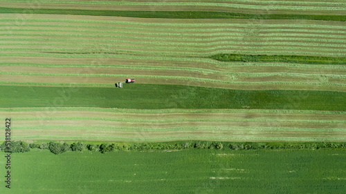 Top aerial view of a tractor mowing hay