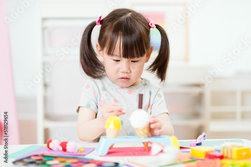 young girl decorating hand made craft for homeschooling