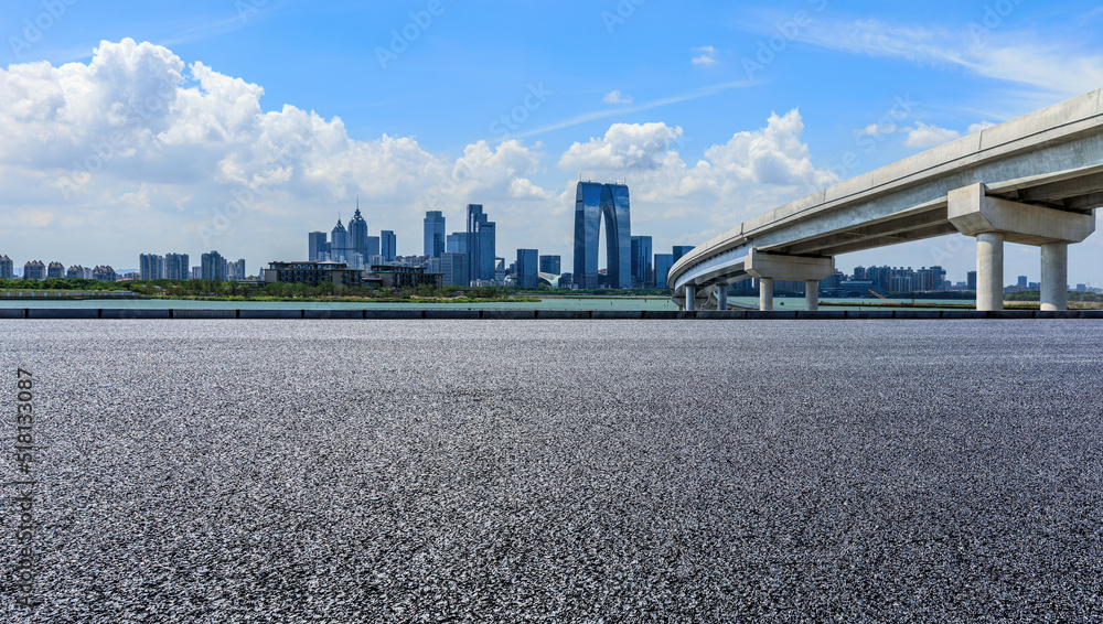 Fototapeta premium Asphalt road and city skyline with modern building in Suzhou, China.