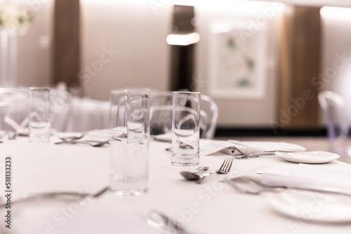 Restaurant table glasses, plates and cutlery close up © Stella Kou