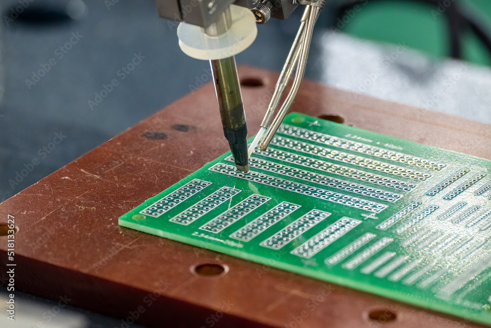 The automatic soldering machine operation with PCB board.