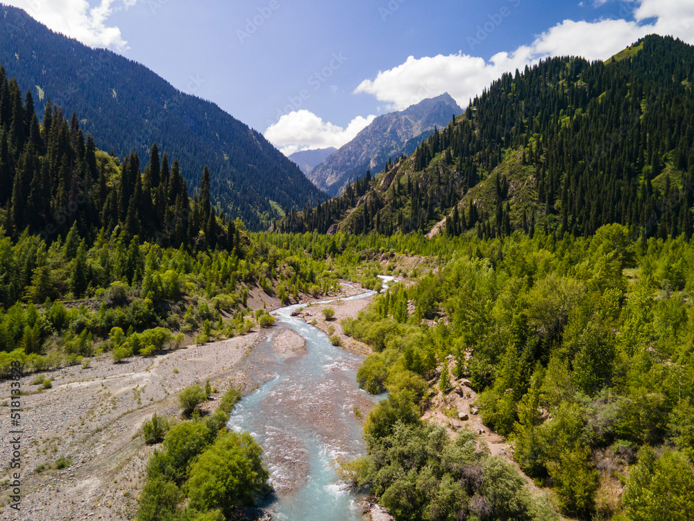 The Issyk River is above the lake. The valley of the mountain river is high in the mountains. Beautiful mountain landscape. Aerial photography of a mountain river. The Issyk River is above the lake. The valley of the mountain river is high in the mountains. Beautiful mountain landscape. Aerial photography of a mountain river.
