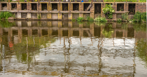 Industrial reflection of Lyons salt waorks in the River Weaver, Anderton Boat Lift, Anderton, Cheshire, UK photo