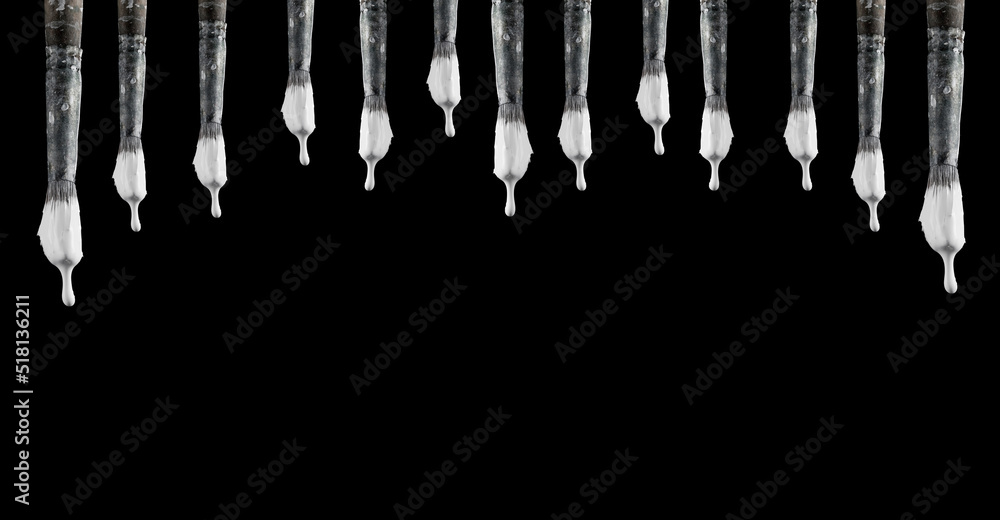 White paint drips from the brushes and drips to the black wall. Photo ...