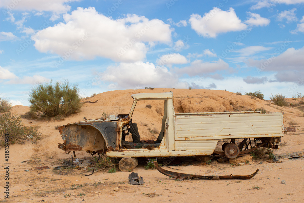 Rusty old wreck abandoned pickup car in Sahara desert, Tunisia