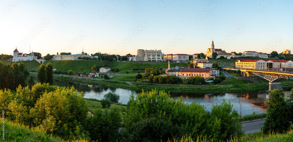 GRODNO, BELARUS JULY 1, 2022: Panoramic view of the historical center of Grodno at sunset. Beautiful city and embankment along the river.