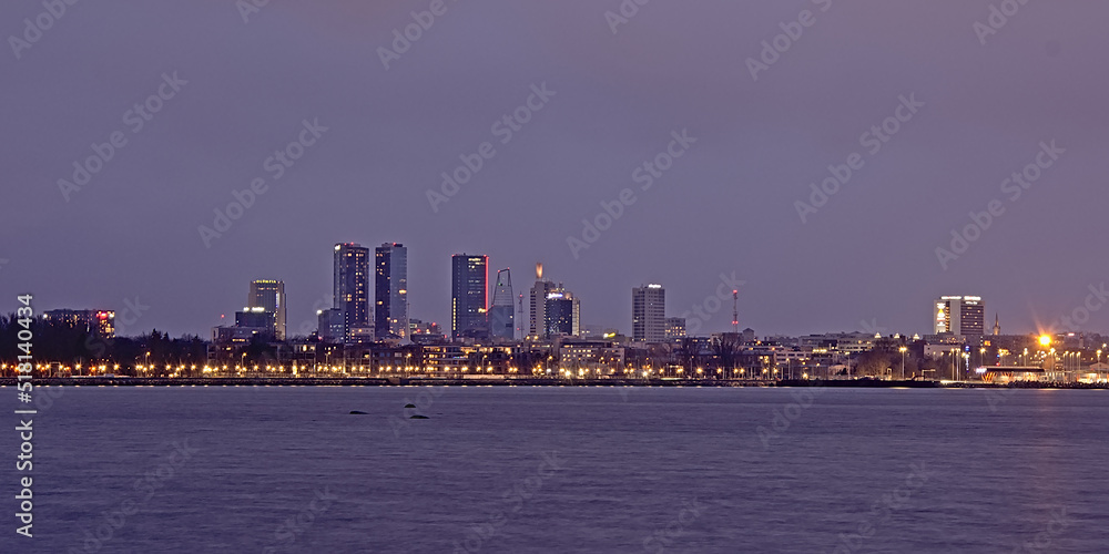 Fototapeta premium Nocturnal view on skyscrapers of the modern district of the city of Tallin,Estonia from across the Baltic sea.