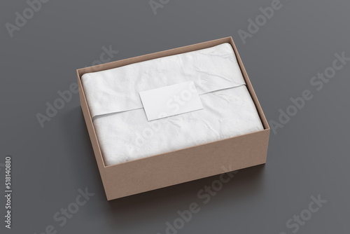 Gift box mock up. Cardboard gift box with blank label or business card on wrapping paper. Black background. Side view.