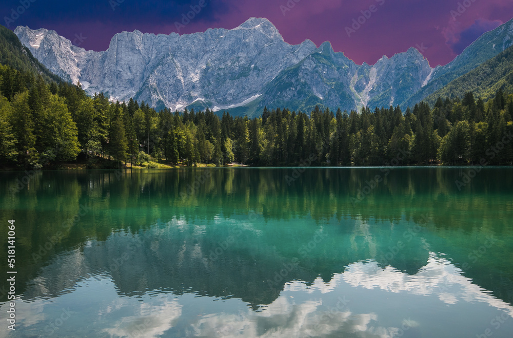 Upper Lake of Fusine during summer sunset. Emerald waters. Tarvisio to be discovered. Friuli