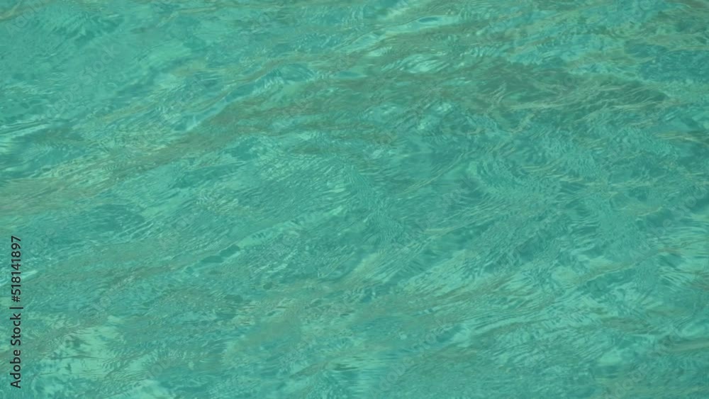 Transparent turquoise water of the Cretan Sea on the shore and a huge tourist ship Transparent turquoise water of the Cretan Sea on the shore and a huge tourist ship