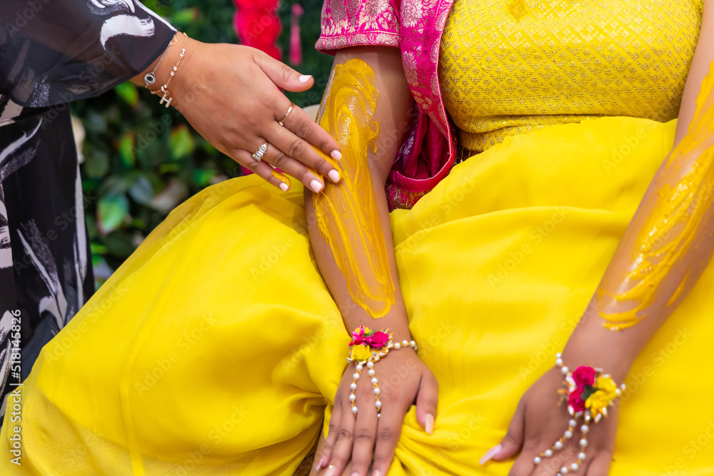 Indian pre wedding turmeric haldi ceremony bride's hands close up