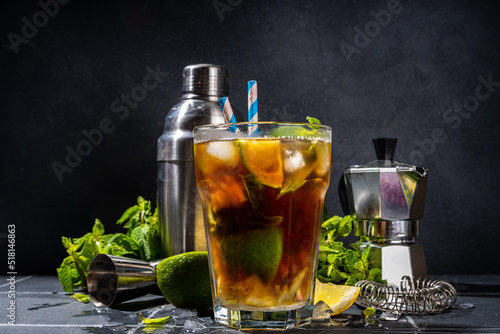 Lavazza mojito mocktail. Strong black espresso coffee cold drink with mojito cocktail, lime, lemon, mint leaves, trendy summer iced beverage on dark background copy pace