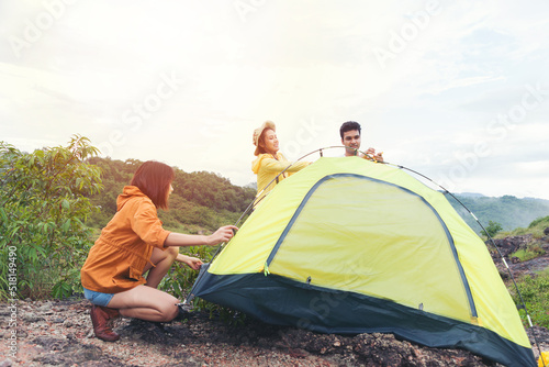 Group of young friends people preparing camping tent for camping outdoor on mountain
